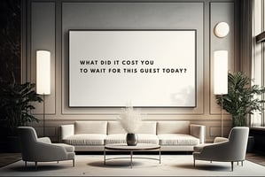 A beautifully styled, modern luxury hotel lounge with minimalist cream furniture and sleek lamps, featuring a large black-framed whiteboard above the sofa that reads in clean, spaced-out typography: "WHAT DID IT COST YOU TO WAIT FOR THIS GUEST TODAY?